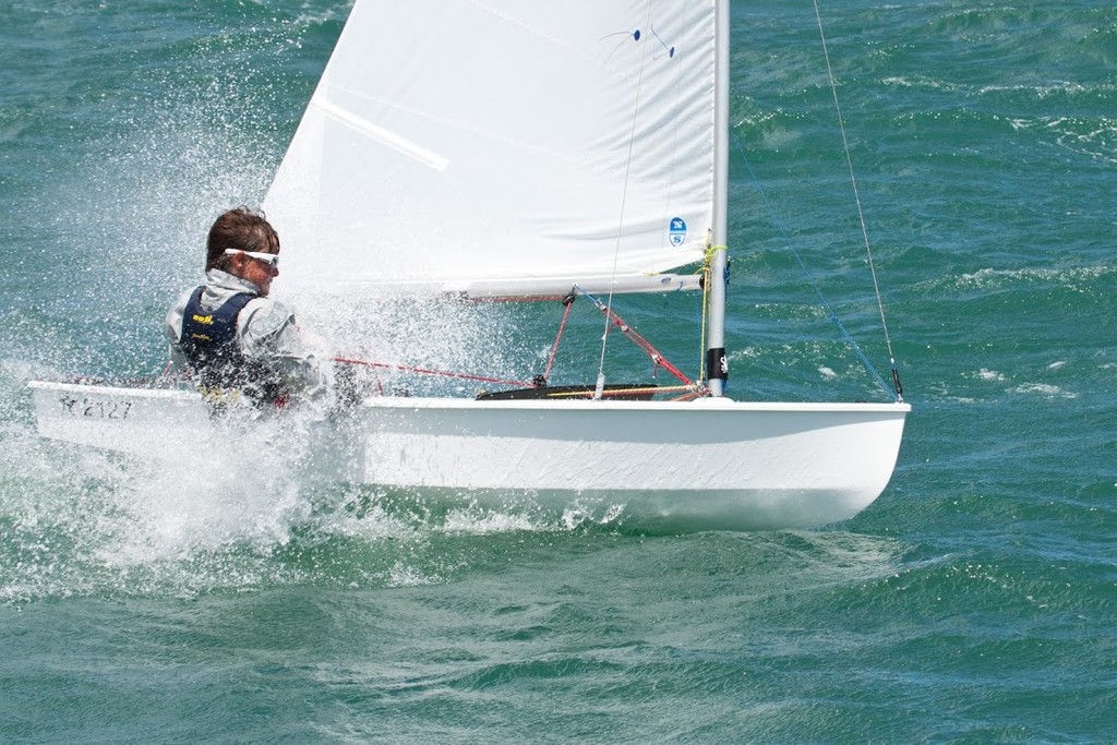 Local sailor George Gautrey powers through the swells on Day 2 © SW